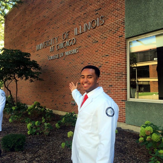 Willard Fountain, UIC UHP Alumni 2017 posing in front of the UIC College of Nursing building