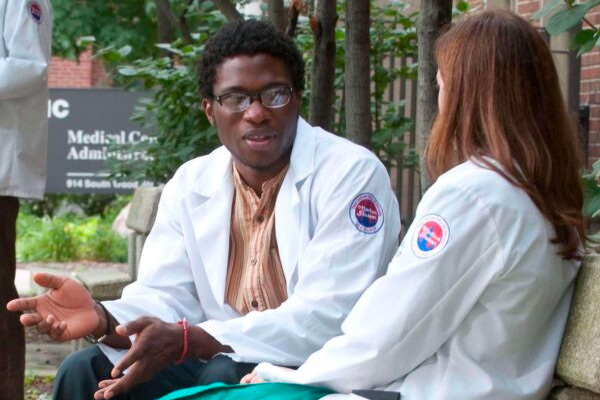 an african american student in a white medical coat